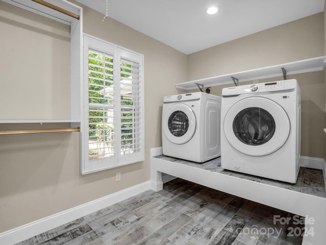 laundry room featuring independent washer and dryer and hardwood / wood-style floors