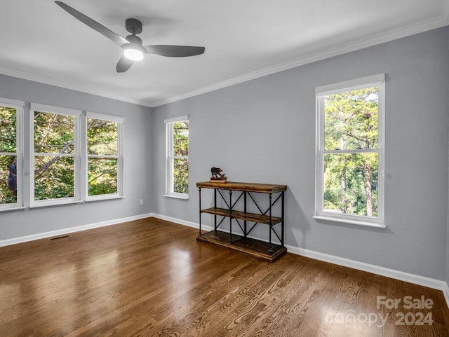 spare room featuring ceiling fan, crown molding, and wood-type flooring