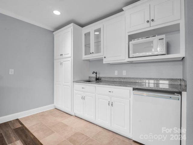 kitchen featuring white cabinetry, ornamental molding, and white appliances