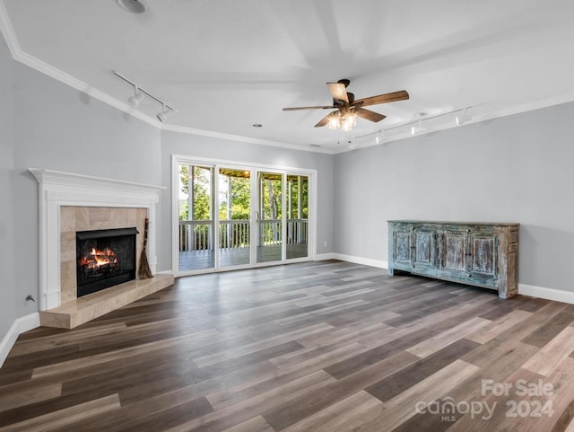 unfurnished living room featuring ceiling fan, a fireplace, crown molding, hardwood / wood-style flooring, and rail lighting