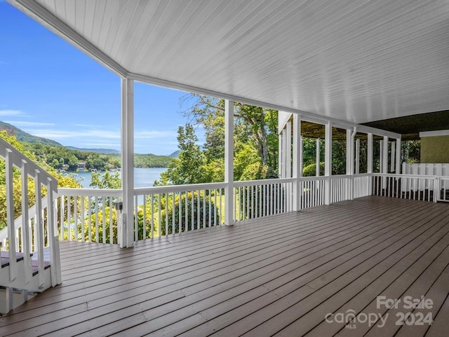 wooden terrace featuring a water view