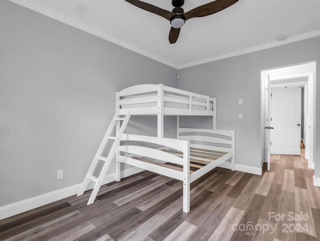 unfurnished bedroom featuring ceiling fan, crown molding, and dark hardwood / wood-style floors