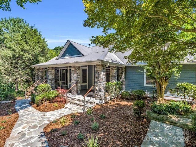 back of property with a porch