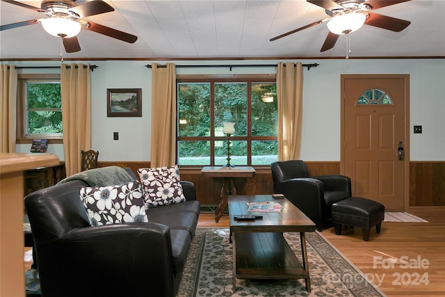 living room featuring ceiling fan, crown molding, and hardwood / wood-style flooring