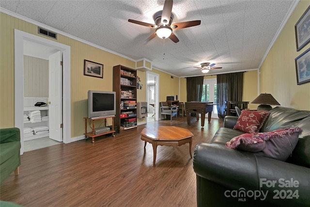 living room with ceiling fan, wood-type flooring, and ornamental molding