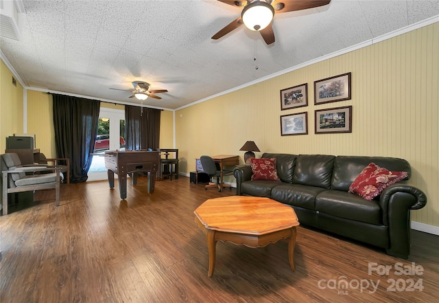 living room with hardwood / wood-style flooring, ornamental molding, and ceiling fan