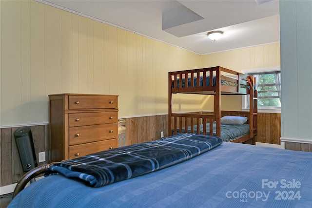 bedroom featuring wood walls