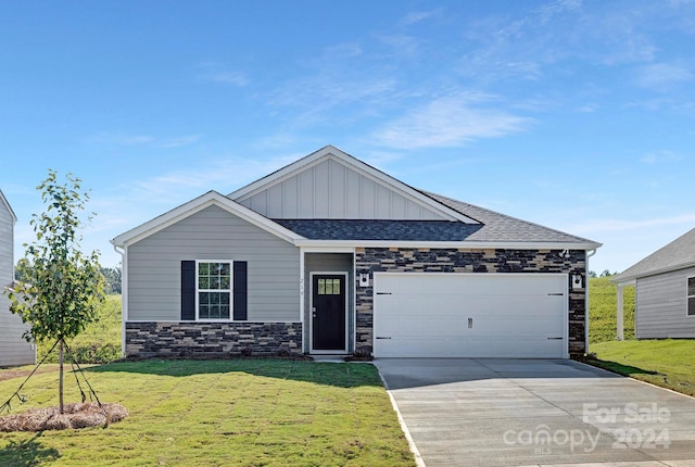 view of front of house with a garage and a front lawn