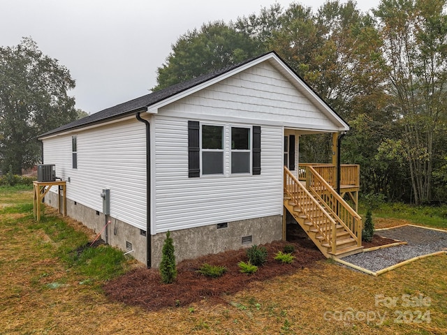 view of home's exterior with a deck and cooling unit