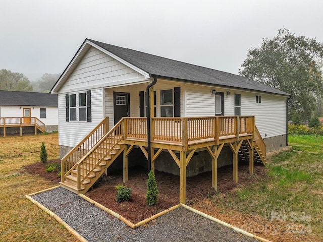 rear view of house featuring a wooden deck