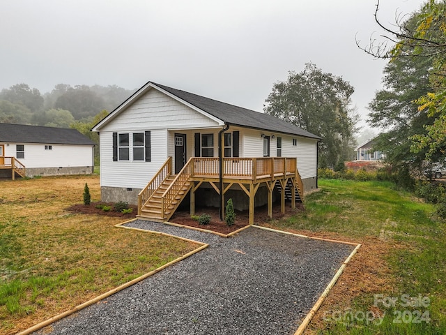 back of house with a yard and a wooden deck