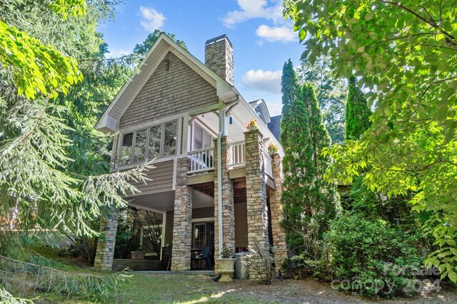 rear view of house featuring a balcony