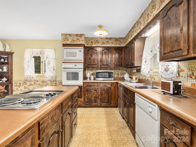 kitchen with decorative backsplash, sink, dark brown cabinetry, and stainless steel appliances