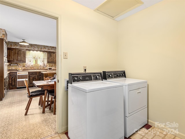 clothes washing area with washer and clothes dryer