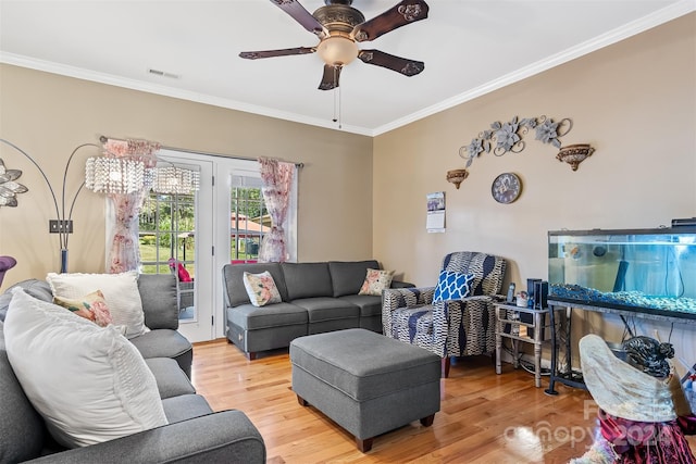 living room with hardwood / wood-style flooring and crown molding