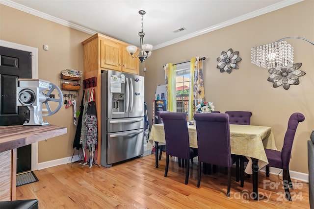 kitchen with stainless steel fridge with ice dispenser, an inviting chandelier, ornamental molding, and light brown cabinets