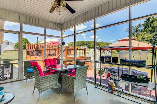 sunroom featuring ceiling fan