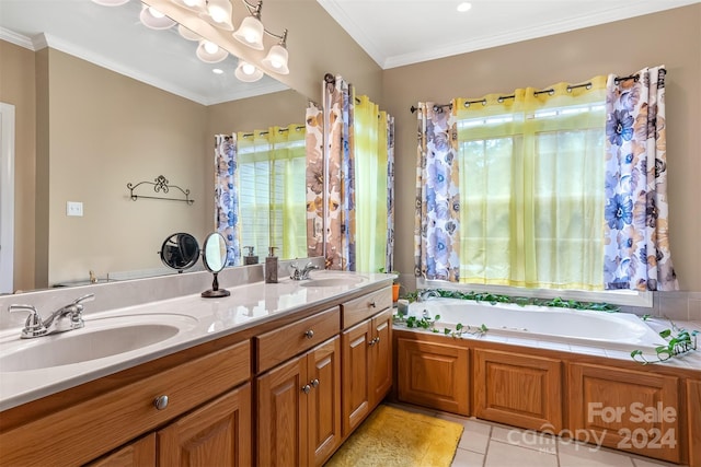 bathroom featuring tile patterned flooring, crown molding, vanity, and a tub