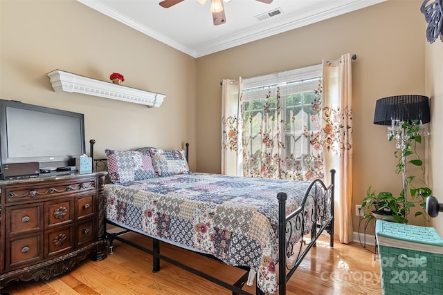 bedroom with ceiling fan, ornamental molding, and light hardwood / wood-style flooring