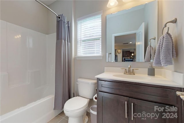 full bathroom featuring tile patterned floors, vanity, toilet, and shower / bath combo with shower curtain