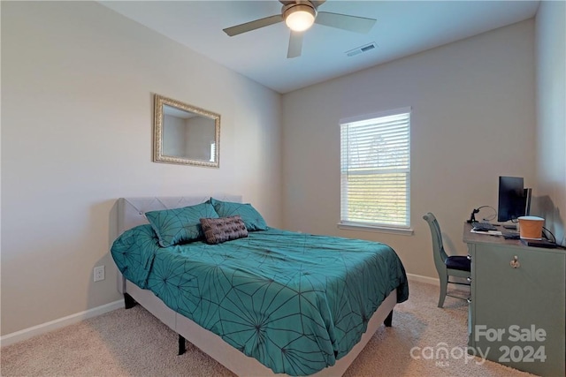 bedroom featuring ceiling fan and light carpet