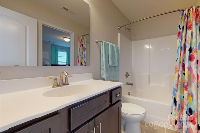 full bathroom featuring tile patterned flooring, vanity, toilet, and shower / bath combo with shower curtain