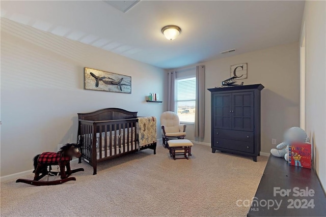 carpeted bedroom with a crib