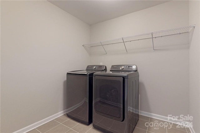 washroom with tile patterned floors and washer and dryer