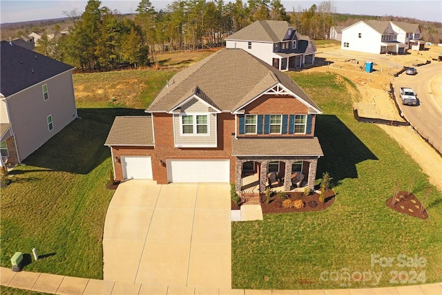 view of front of property with a front lawn and a garage