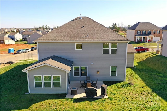 rear view of house featuring a patio area and a lawn