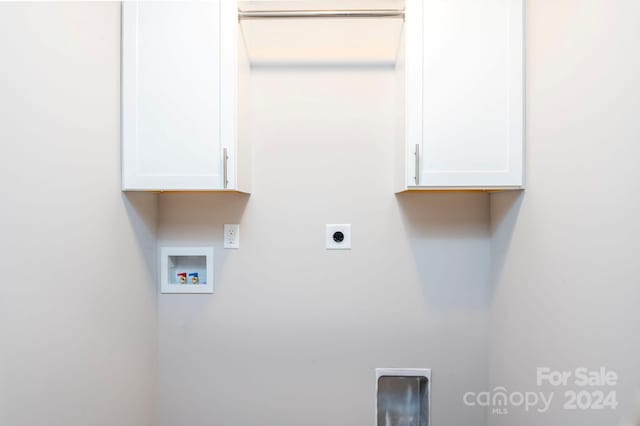 laundry room featuring washer hookup, hookup for an electric dryer, and cabinets