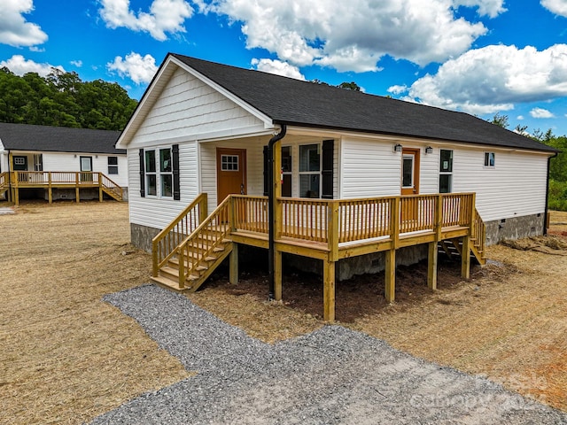 back of house with a wooden deck