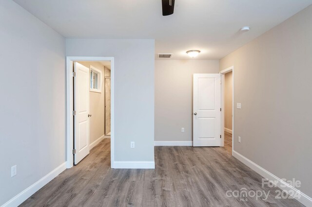 unfurnished bedroom featuring ceiling fan and light hardwood / wood-style flooring