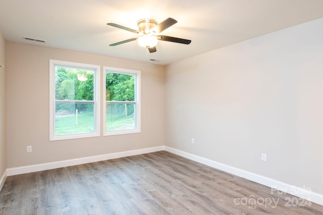 unfurnished room with ceiling fan and light wood-type flooring