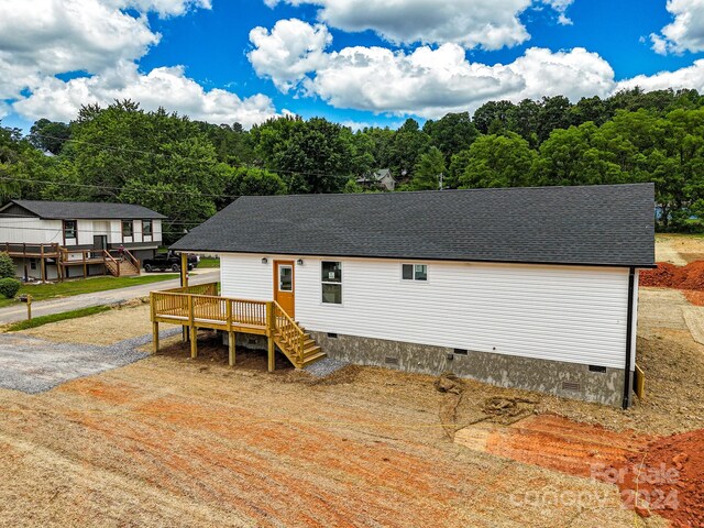 back of property featuring a wooden deck