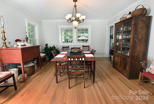 dining space with plenty of natural light, ornamental molding, light hardwood / wood-style flooring, and a notable chandelier