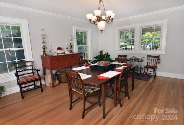 dining room with a healthy amount of sunlight, ornamental molding, and light wood-type flooring