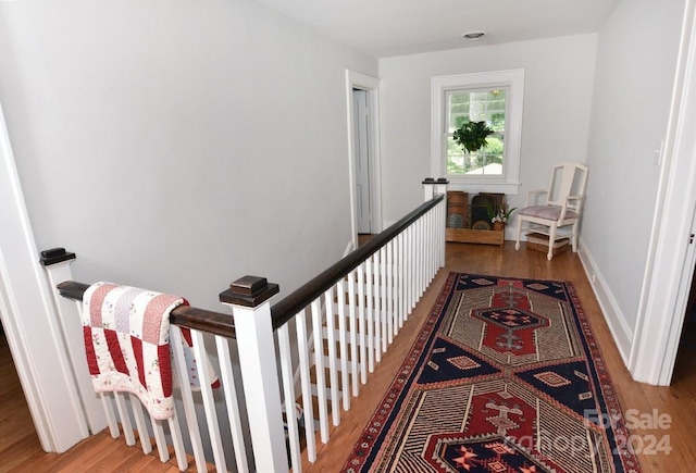 stairway with hardwood / wood-style flooring