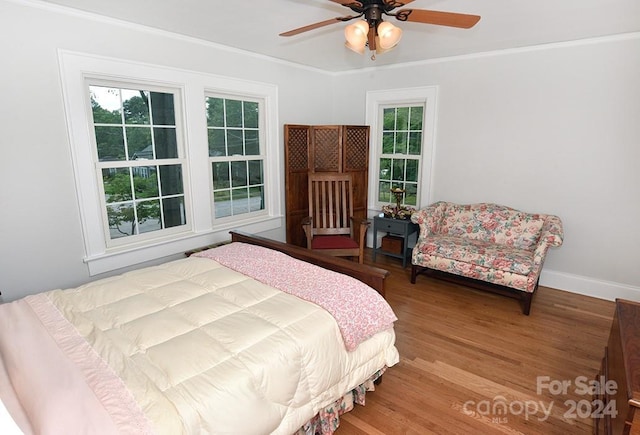 bedroom featuring ceiling fan, ornamental molding, and hardwood / wood-style flooring