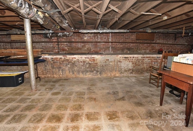 basement with brick wall