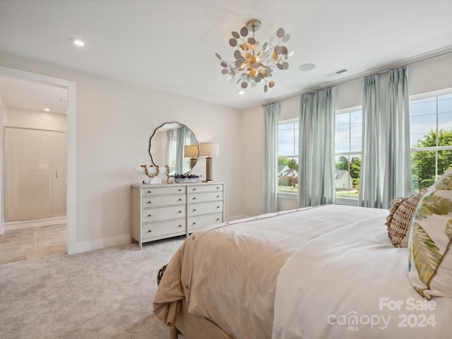 bedroom with an inviting chandelier and light colored carpet