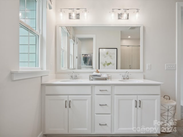 bathroom featuring an enclosed shower and vanity