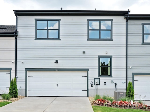 view of front of home featuring central AC and a garage