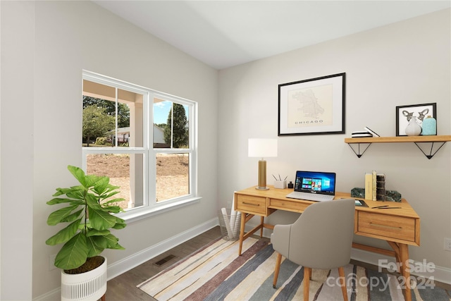 home office with hardwood / wood-style flooring and a wealth of natural light