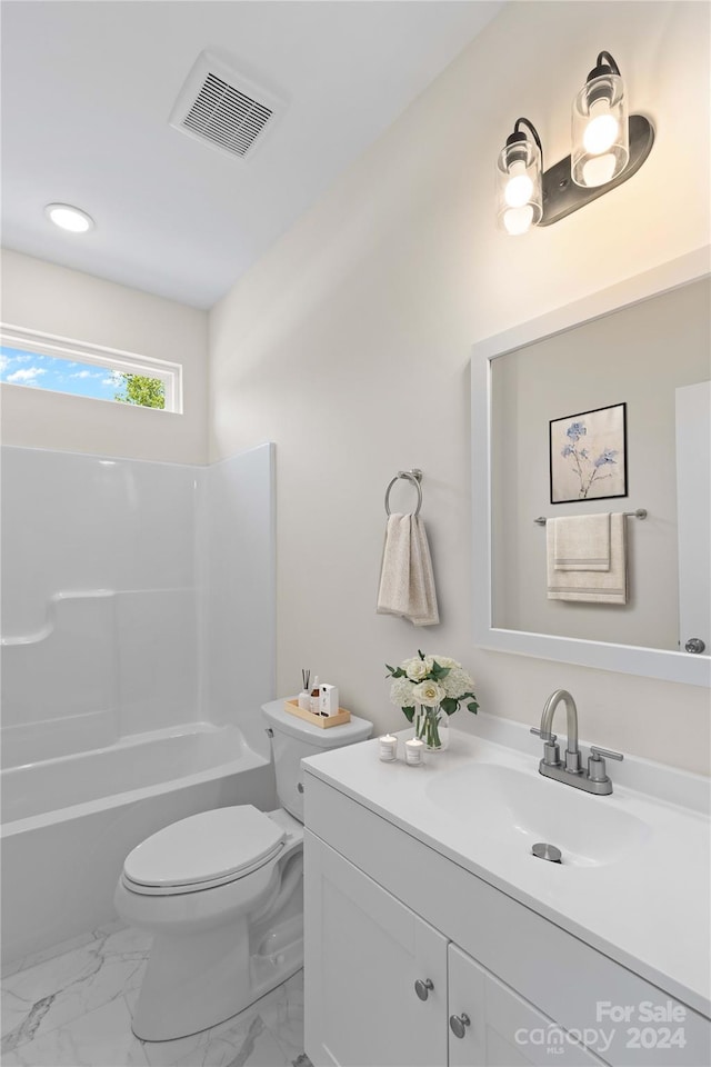 full bathroom featuring vanity, washtub / shower combination, and toilet