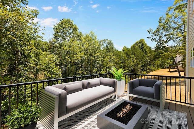 wooden deck featuring an outdoor fire pit