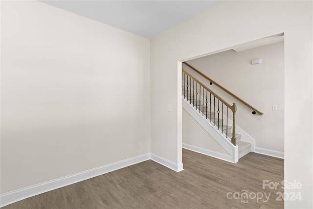 staircase featuring wood-type flooring