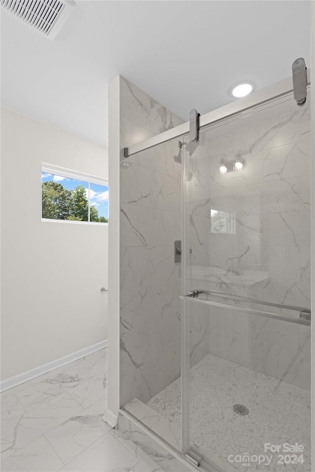 bathroom featuring a shower with door