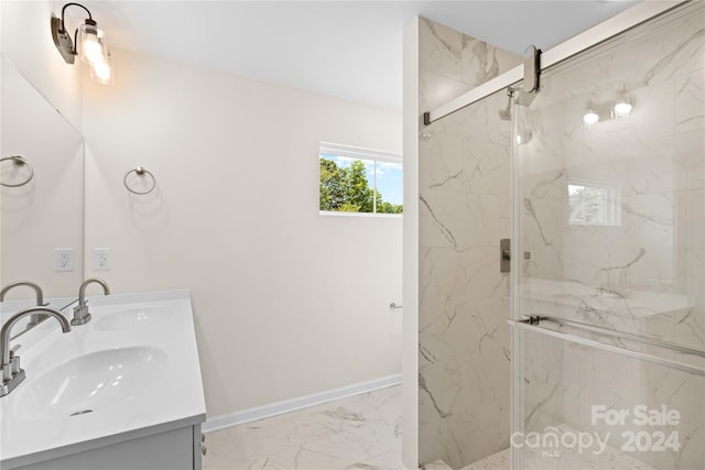 bathroom featuring a shower with door and vanity