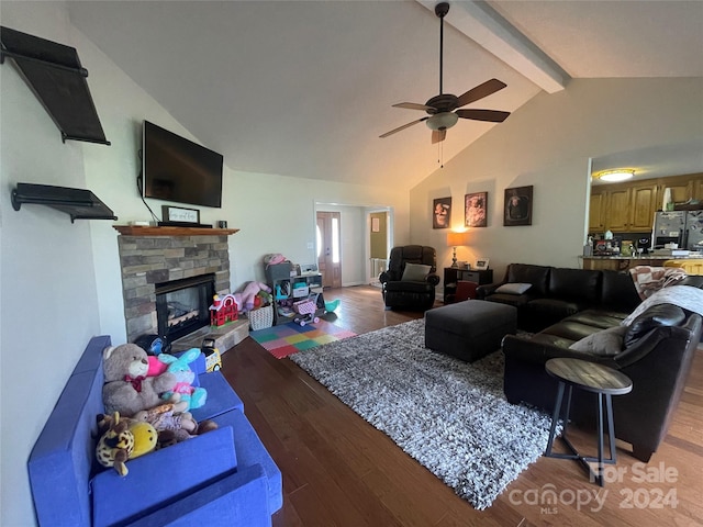 living room featuring dark hardwood / wood-style floors, a fireplace, vaulted ceiling with beams, and ceiling fan